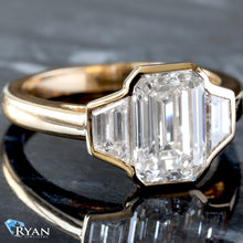 Load image into Gallery viewer, 3.13ctw Bezel Set Three Stone Emerald Center and Trapezoid Sides on High Polished Shoulders Ring
