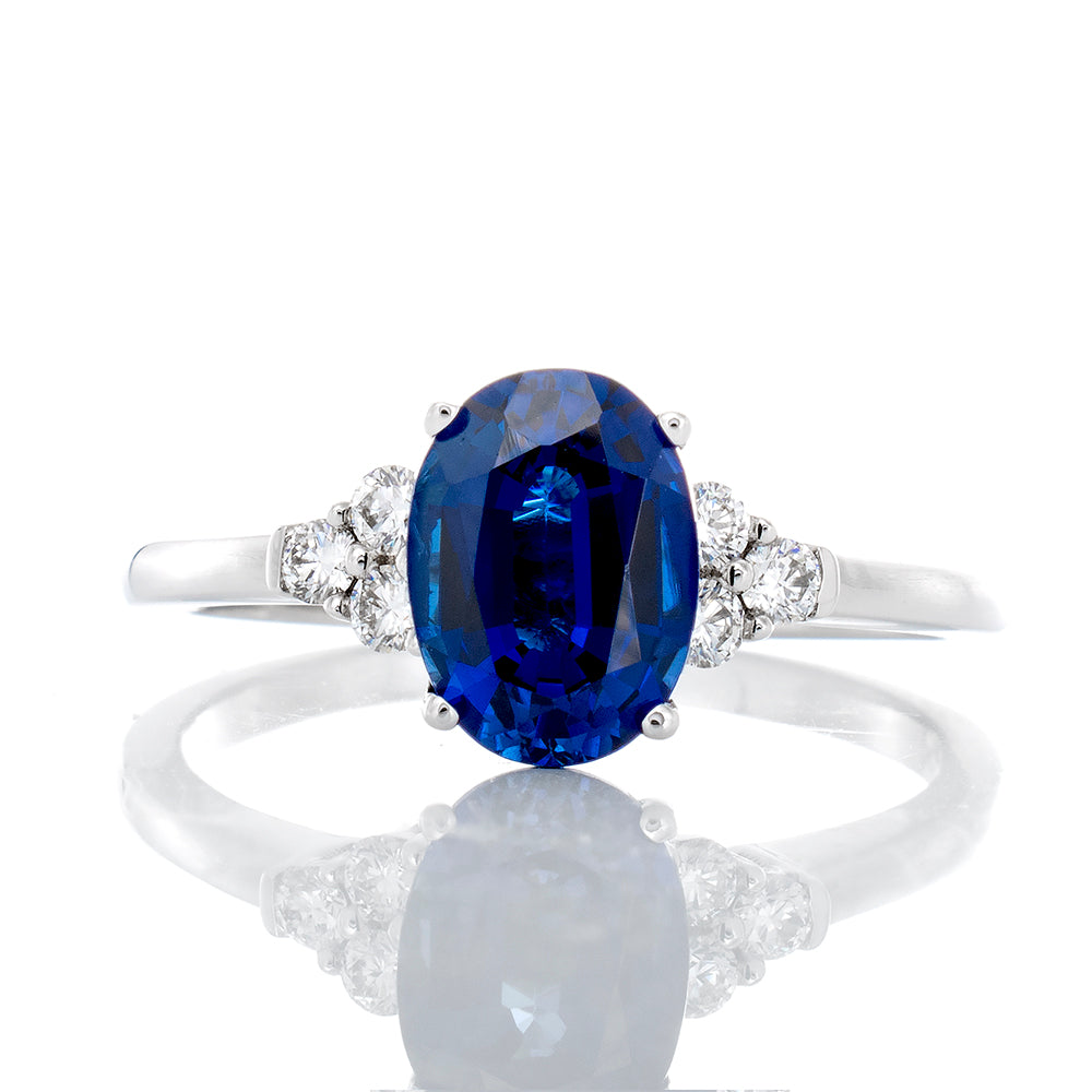0.15ctw Three Diamond Cluster with Solitaire Oval Cut Blue Sapphire Ring