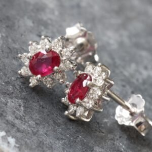 0.15ctw Oval Ruby with Three Prong Diamond Halo Studs
