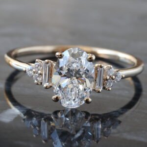 1.15ctw Oval Diamond Center with Baguette Shoulders and Fluer De Lis Cluster Accents Ring 14K Yellow Gold