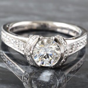 LAB RING GW 18K 1.45CTW ROUND BRILLIANT CENTER IN HALF BEZEL SET AND SHARED PRONG CHANNEL BRIDGE DESIGN SHOULDERS