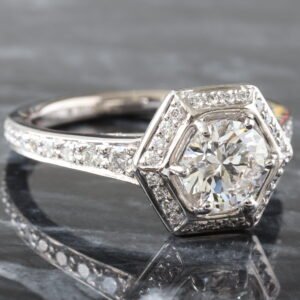 LAB RING GW 18K 1.35CTW ROUND BRILLIANT CENTER WITH ART DECO HEXAGONAL HALO AND GRADUATING SHARED PRONG CHANNEL UPSWEPT SHOUDLERS